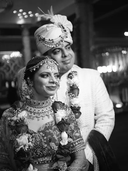 A timeless black and white portrait of the bride and groom, capturing a moment of quiet reflection.