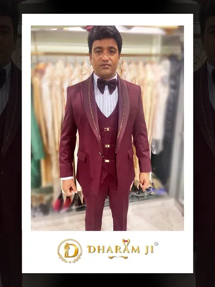 A client looking sharp in a custom-fitted maroon three-piece tuxedo. The coordinated bow tie and waistcoat complete the polished look.