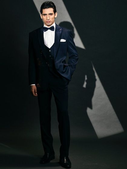 Get ready to turn heads with this dark blue velvet suit, embellished with sequins for a bold and stylish flair.