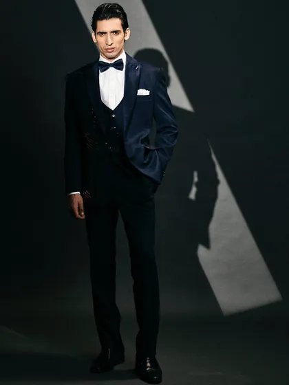 Get ready to turn heads with this dark blue velvet suit, embellished with sequins for a bold and stylish flair.