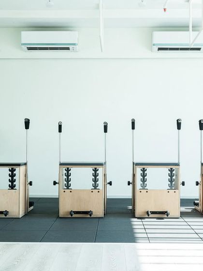Our lineup of Pilates Chairs, ready for a class. This equipment is designed to make you move better, look better, and feel stronger.