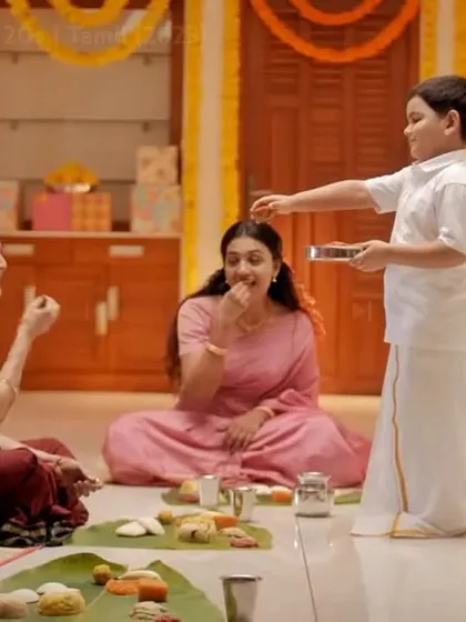 Another still from the Surf Excel Onam ad, showing the family enjoying a traditional sadhya (feast) on a banana leaf.