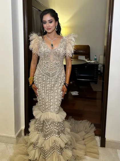 The full view of this incredible cocktail gown and makeup. The soft glam ensures the bride is the star, looking elegant and ready for her party.
