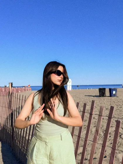 A playful, candid moment from the same beach photoshoot.