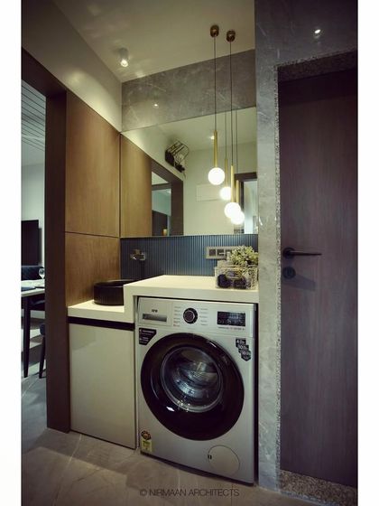 This compact utility and wash area shows our expertise in space planning. We managed to fit a washing machine, a stylish washbasin, and storage into a small passage without it feeling cramped.