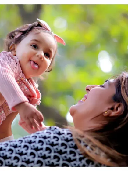 A mother lifting her daughter up in the air, both sharing a laugh. These are the joyful, candid moments we love to capture in our outdoor family sessions.