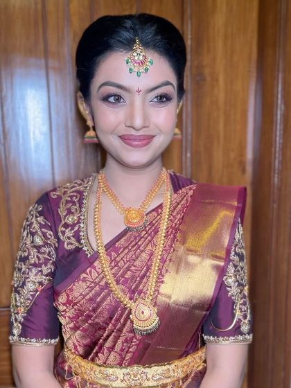 A close-up of the bride, her neat bun allowing her beautiful jewellery and features to take center stage.