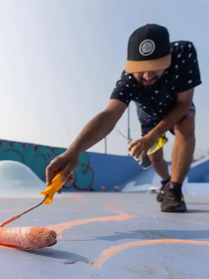 Getting down to the details with a roller. Large-scale pieces like this require a mix of techniques, from broad strokes to fine spray can work.