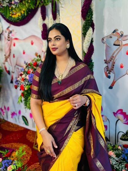 A client looking stunning in a yellow and purple Kanjeevaram saree. The custom purple blouse is made from the saree's border fabric for a perfect match.