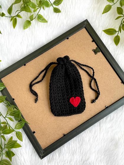 A simple and elegant black drawstring pouch with a small red heart. These are a great reusable alternative to gift wrap.
