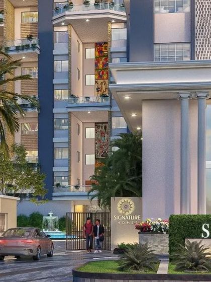 The entrance to the 'Signature Homes' housing project in Ranchi. The landscape design uses a variety of green textures and heights, along with majestic palm trees, to create a mesmerizing and upscale first impression.
