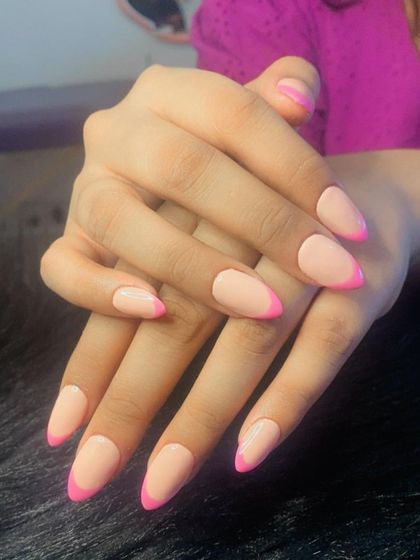 A matte nude base with glossy, bright pink French tips for a fun contrast in textures and colors.