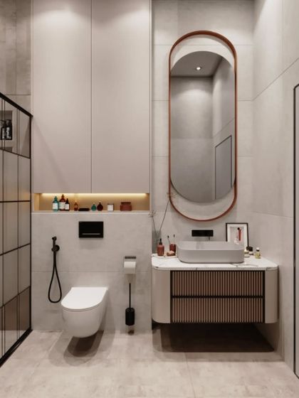 This minimalist bathroom design features a floating vanity with a ribbed-texture drawer front. The clean lines are complemented by a simple, elegant oval mirror and a built-in storage niche with backlighting.