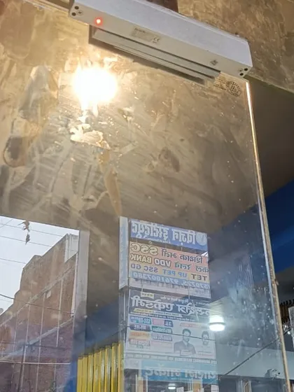 An EM lock installed on the glass door of the Kanpur gym. The red indicator light shows that the lock is currently engaged and the door is secure.