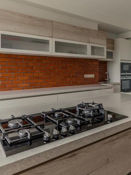 The island cooktop in Hina Gandhi's kitchen is a centerpiece for cooking and interaction. The placement is part of our work triangle philosophy, ensuring an efficient and comfortable cooking experience.