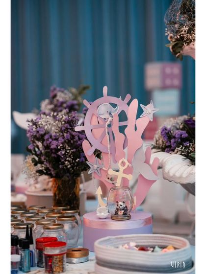 An activity table set up for the kids, featuring ocean-themed crafts and jars of supplies. I believe in providing creative and engaging activities to keep the little ones entertained.