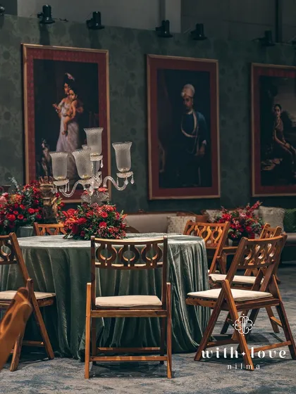 A wide view of the dining area, with the art-adorned walls creating a unique and sophisticated backdrop for the sangeet dinner.