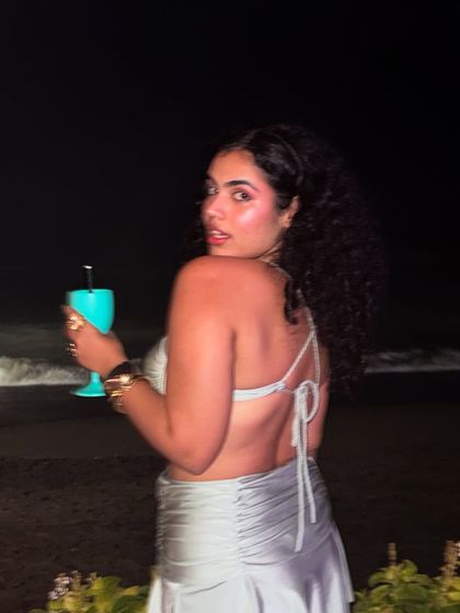 Who brings the big hair energy to the club? She does. This photo from Finns Beach Club in Bali is all about a fun, party-girl vibe, with big curly hair and a cocktail in hand.
