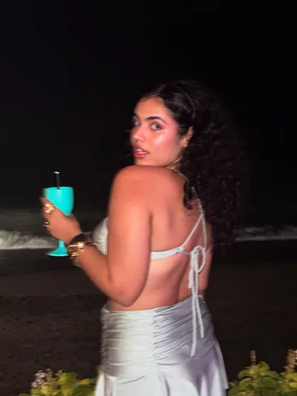 A glance over the shoulder at the beach club. The back of this metallic co-ord has a simple tie detail, adding a delicate touch to the party-ready outfit.