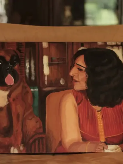 This commissioned acrylic painting of a woman and her boxer is set in a warm, cozy room, creating a feeling of home and companionship.