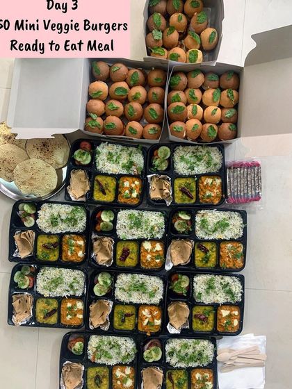 An order of 50 Mini Veggie Burgers along with ready-to-eat meals for an event.