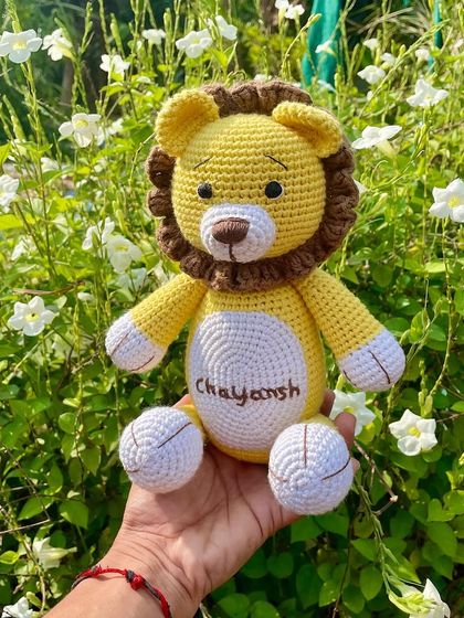 A personalized lion plushie with the name "Chayansh" embroidered on his belly. This sunny yellow lion is ready to be a brave and loyal friend.