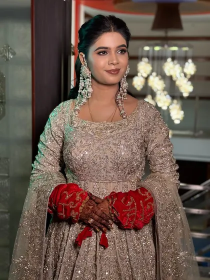 A portrait of the happy bride, her soft makeup complementing her glamorous gown.