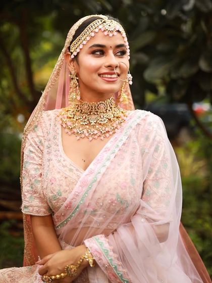 The bride looks like she's stepped out of a fairytale. The soft, romantic makeup and pastel lehenga create a truly magical look.