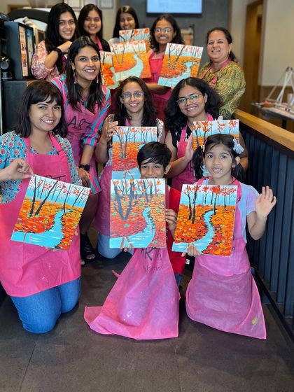 A group of adults and children with their autumn landscape paintings. My workshops are designed to be enjoyable for all ages.
