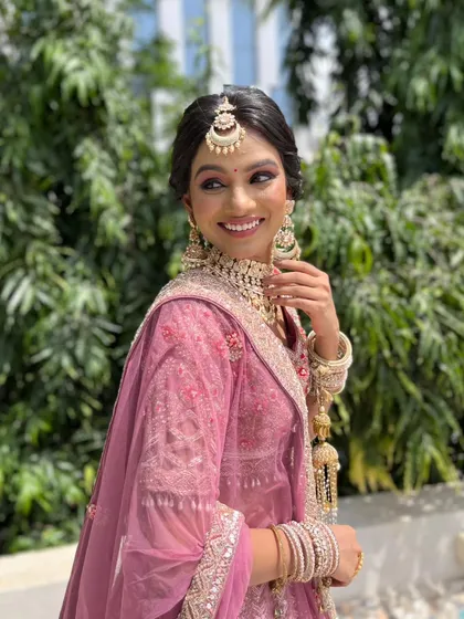 The bride's joyful smile says it all. The makeup is light and airy, perfect for celebrating in the sun.