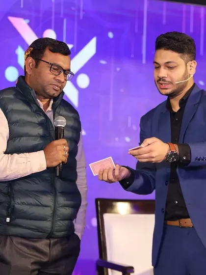 Explaining the setup for a card trick to a volunteer on stage. Even when the trick seems simple, the conclusion is always something nobody sees coming.