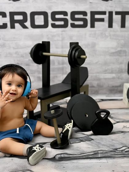 Getting in the zone with his headphones on. This playful detail adds another layer of fun to the CrossFit and gym-themed photoshoot.