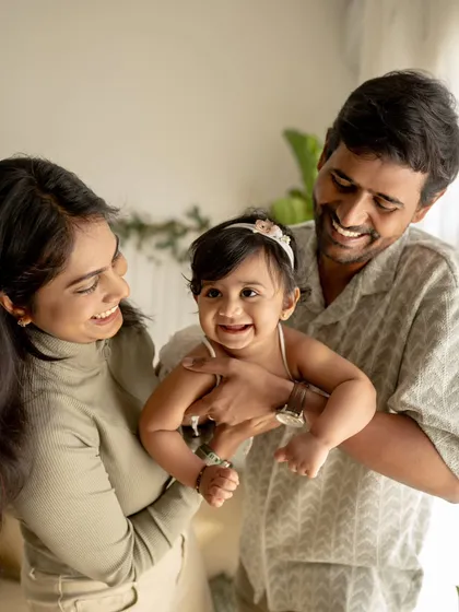 A family of three, full of smiles and laughter.