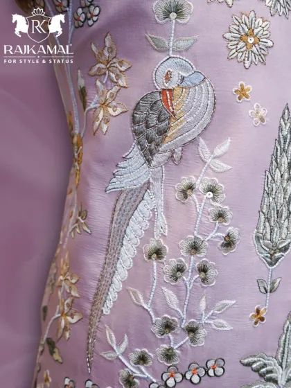 This close-up highlights the exquisite threadwork on a pastel Jodhpuri suit. The design features a beautifully detailed bird perched on a branch, showcasing the fine craftsmanship and artistic storytelling I bring to my ethnic wear collections.