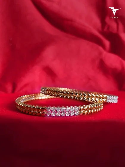 A pair of elegant diamond bangles. With a graceful leaf-like design and radiant shine, these are perfect for adding a touch of luxury to your daily life.