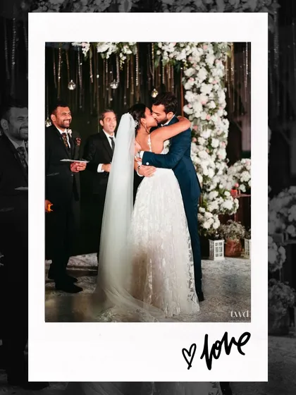 "Love." A simple word for a profound moment. This polaroid-style photo captures the first kiss after the vows, a perfect seal to their promises.
