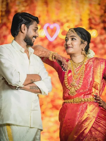 A happy couple posing for a photo. The bride's makeup is natural and radiant, letting her joy be the main focus.