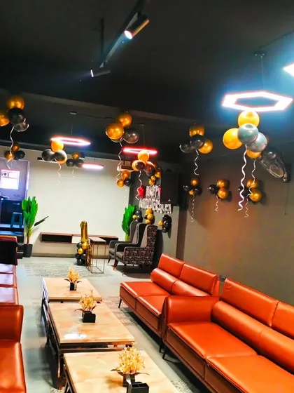 Another perspective of the lounge decoration, showing how the balloons are spread across the room to create a cohesive party environment.