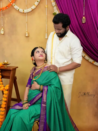 A loving couple portrait from a traditional baby shower-themed shoot. The festive decor and their happy expressions capture the joy of the celebration.