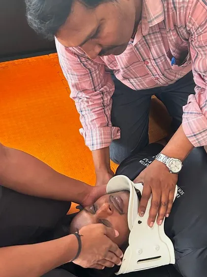 A duplicate of our team learning how to stabilize a potential neck injury.