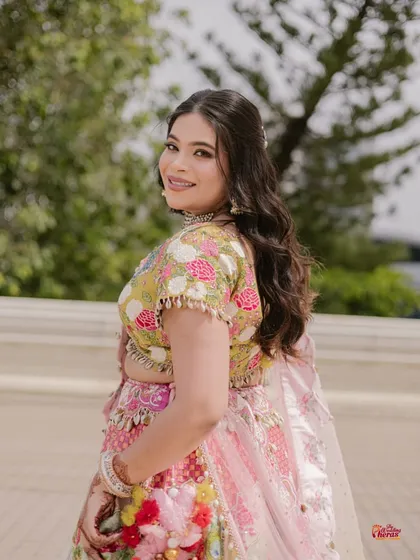 Pre-wedding events are all about color and joy. For this mehendi ceremony, I designed a fresh, vibrant look with glowing skin and soft waves to complement the bride's colorful floral lehenga.