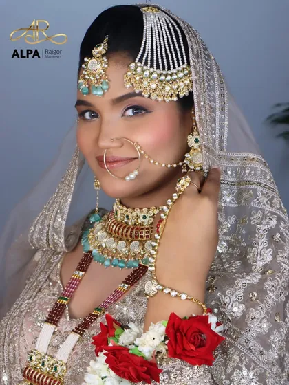 An elegant Valima or Reception look for the modern bride. This style features soft, glowing makeup with subtle pink tones and intricately styled jewelry, creating a look of timeless grace.