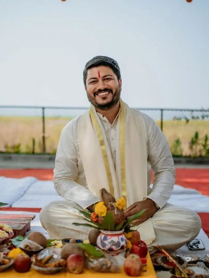 A portrait of the groom during the wedding puja, looking happy and serene.