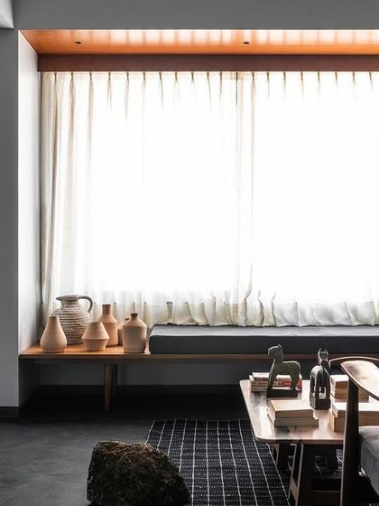 A long view of the window seating I designed for this living room. The dark upholstery grounds the bright space, and the low bench keeps the view open and unobstructed.