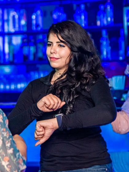 A guest grooving to the beat. The blue lighting and energetic crowd create an amazing party atmosphere.