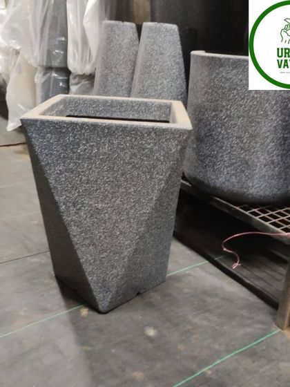 A dark grey, geometric fiber pot.