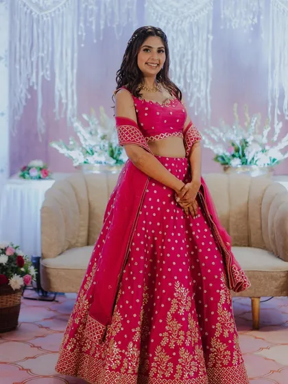 Kajol looking stunning in a bright pink lehenga. Her makeup is kept soft and glowing to balance the vibrant color of her outfit.