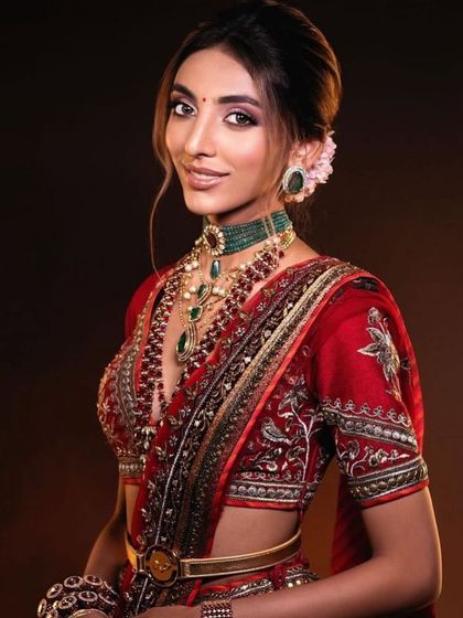 A smiling portrait of the bride in red. This shot shows how my makeup technique ensures the bride can express herself freely without worrying about her makeup looking heavy or unnatural.