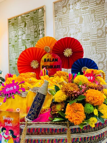 Holi is a festival of pure joy, and this 'Balam Pichkari' hamper captures that energy. I moved beyond the usual dry fruit box, presenting them in festive yellow potlis alongside colorful pinwheels, a decorative pichkari, and fresh marigolds for a truly desi celebration.