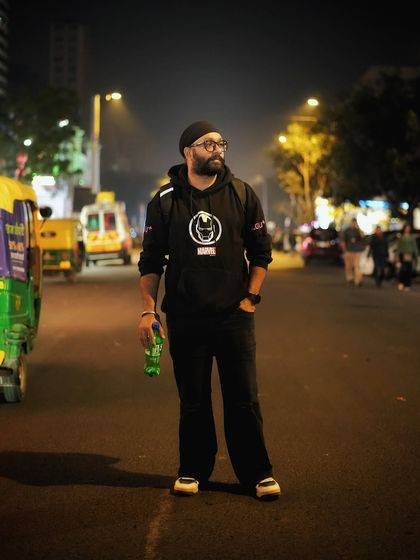 A self portrait on a quiet city street at night. This shot captures the moody, atmospheric vibe of Delhi after dark, with the streetlights creating long shadows and a cinematic feel.